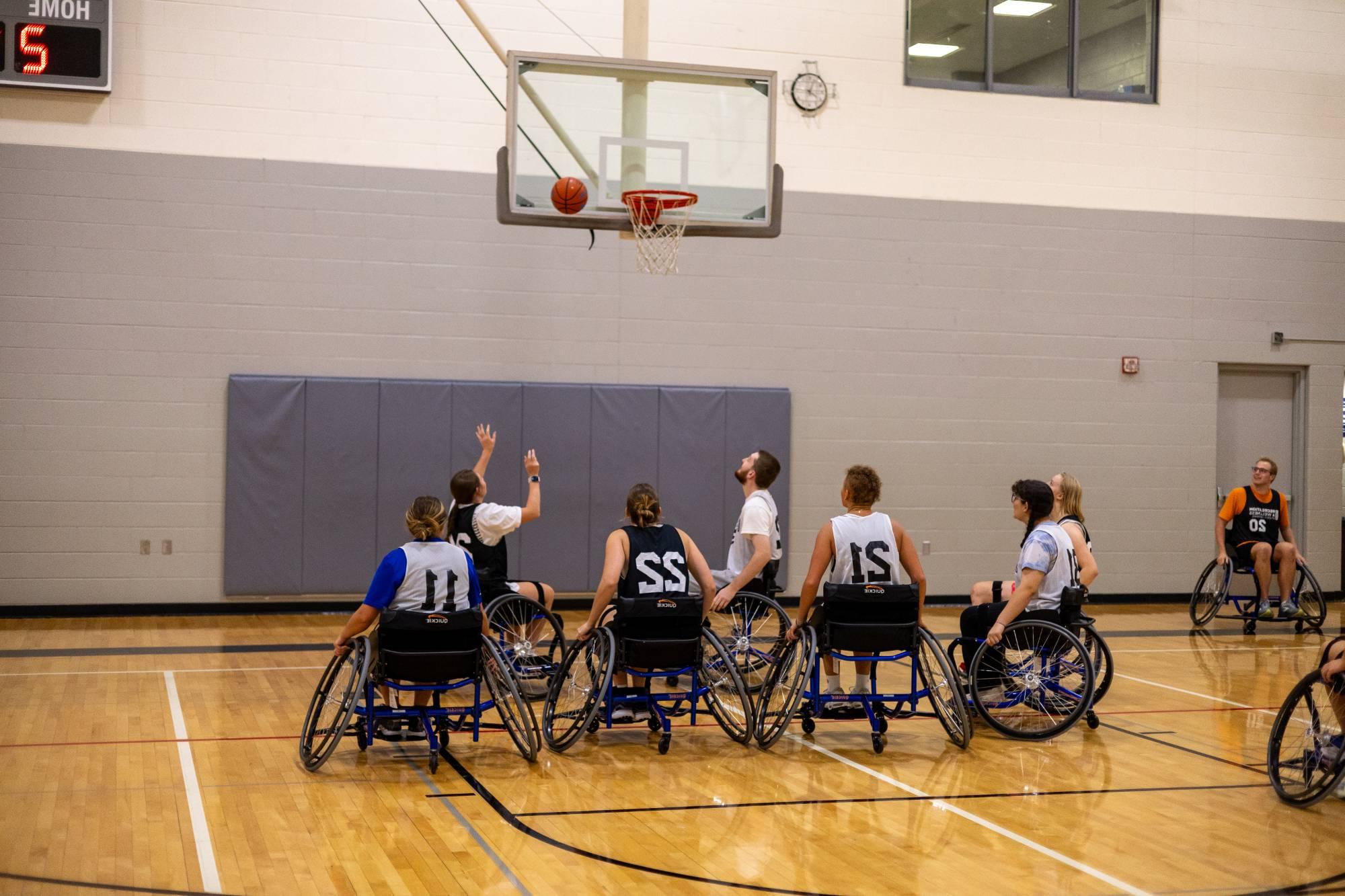 Students playing wheelchair basketball at an adaptive sports intramural sporting event